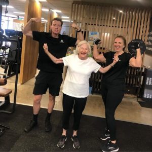 Catalyst 24/7 Fitness members laughing and showing arm muscles